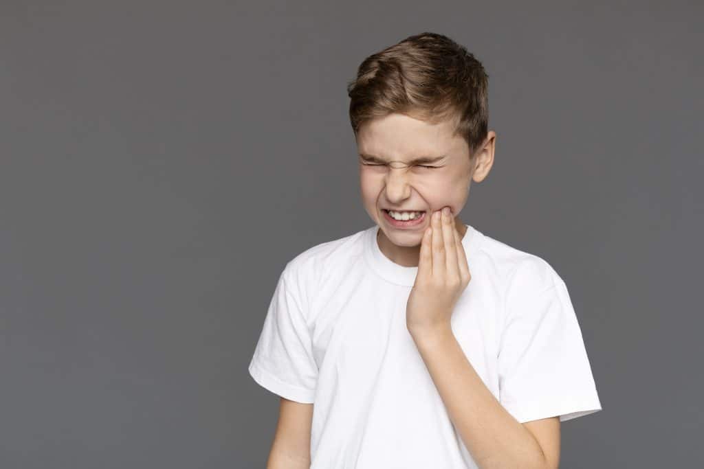 Teen Boy With Acute Toothache, Grey Background